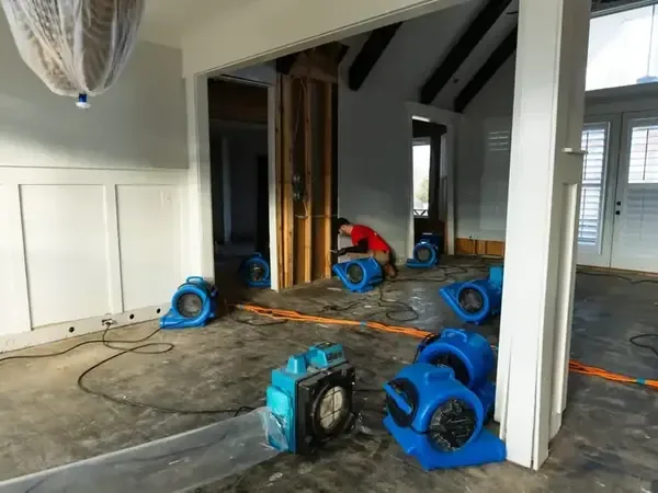Air movers drying an open-plan room after a water loss
